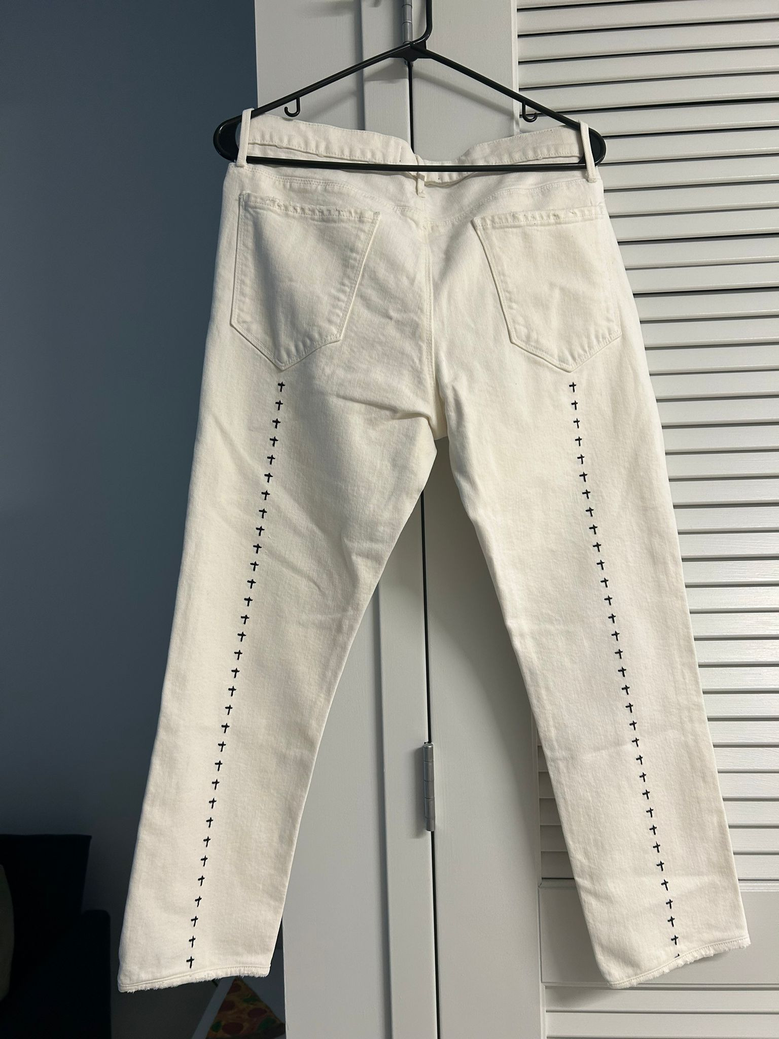 White jeans with cross embroidery